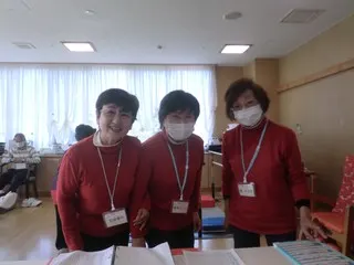 赤い服を着た3人の運動サポーターさんたち